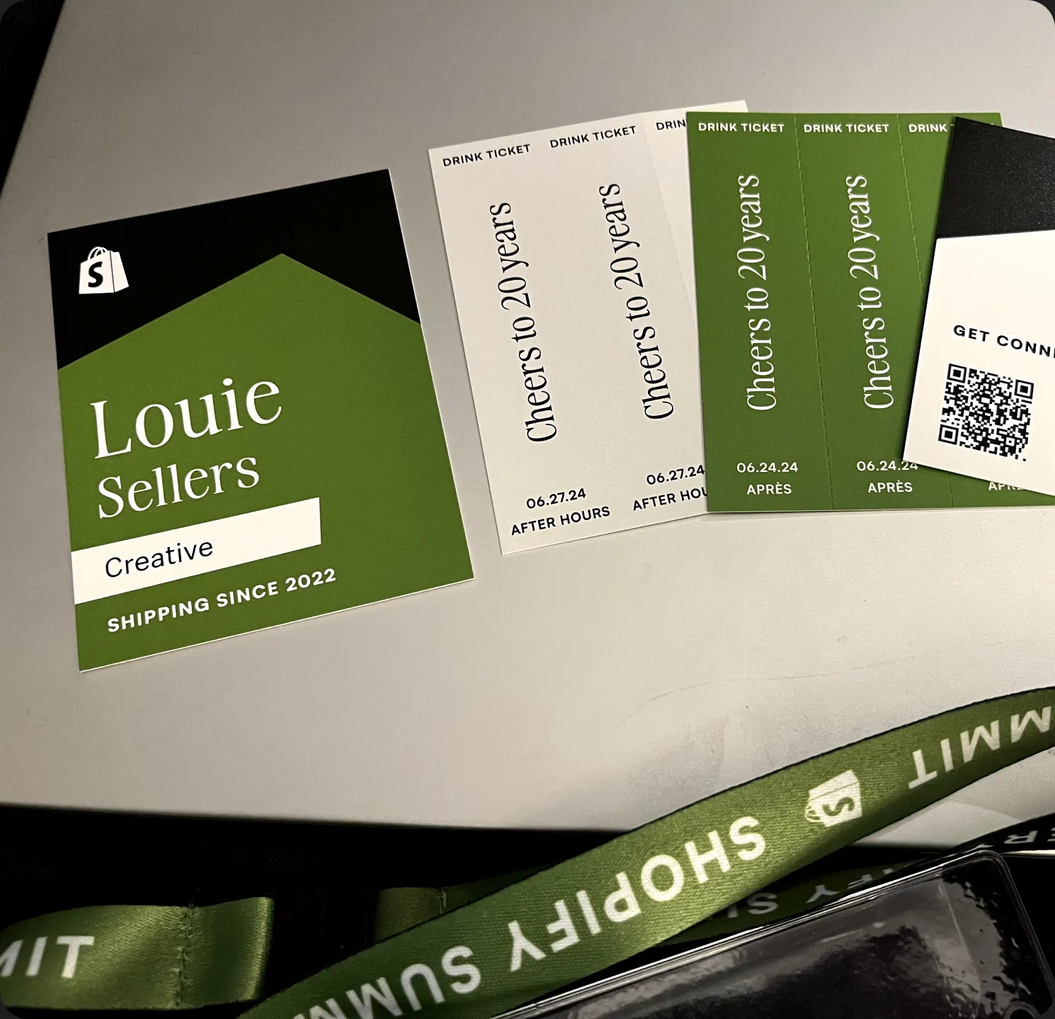 My Shopify Summit badge, ‘Shipping since 2022’, with drink tickets and a lanyard