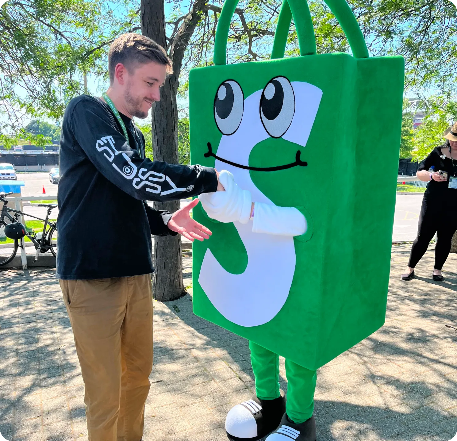 Louie shaking hands with Shoppy, the Shop app mascot